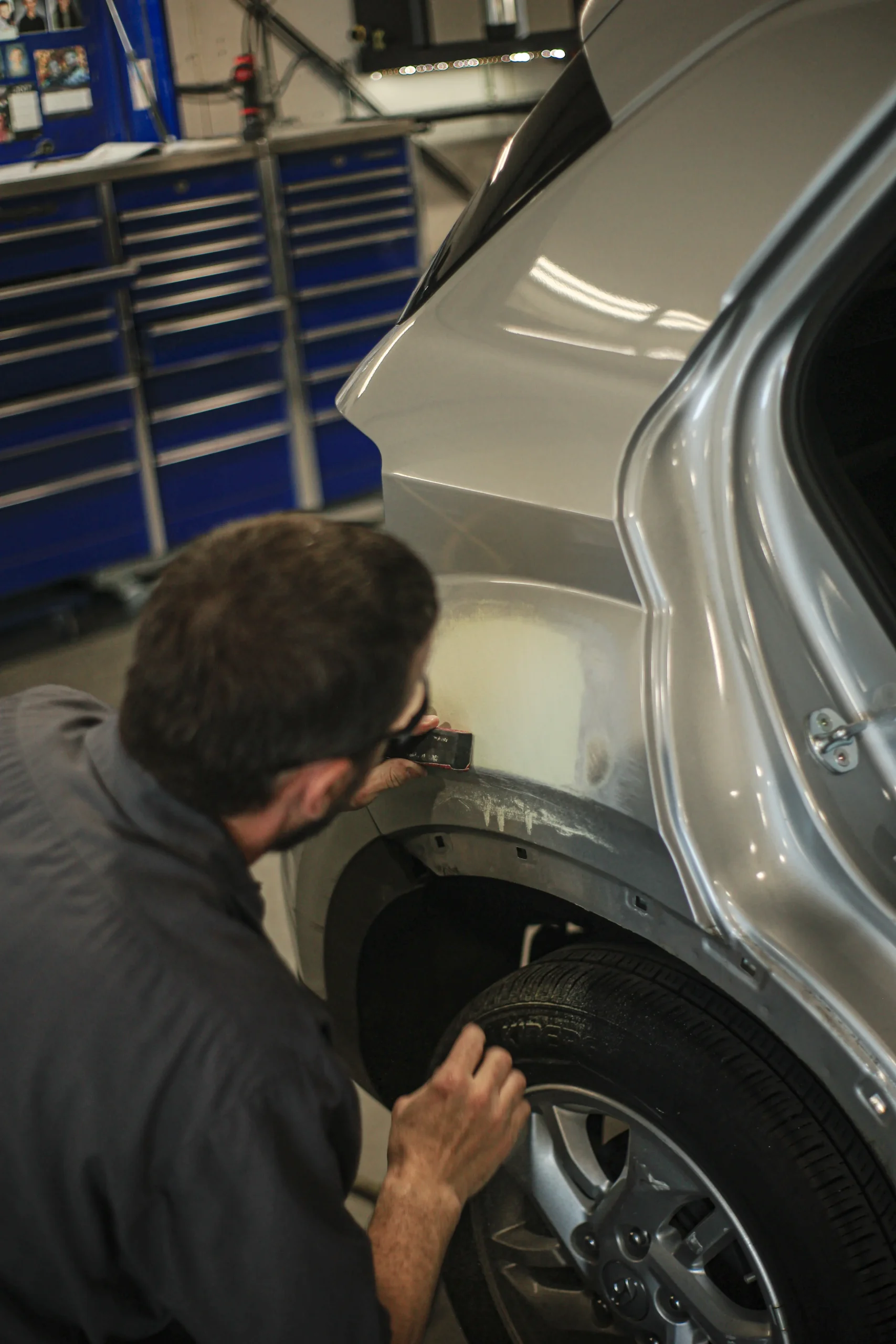 Technician performing filler panel repair on a Hyundai Venue in Tacoma shop